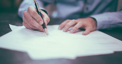 Person at Desk Filling out Application Forms